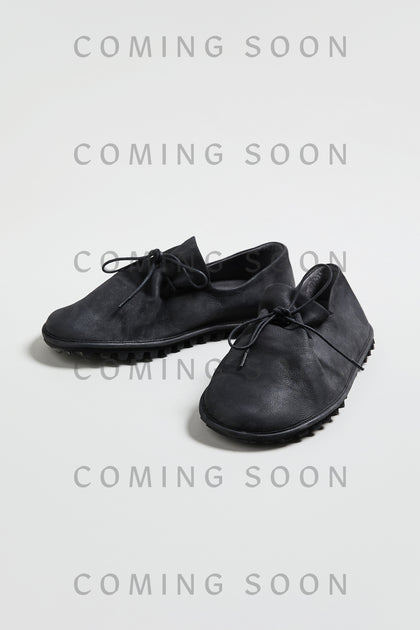 A pair of Crushed Leather Lace Up Shoes, style LOFI9944-SS26 in black, is displayed on a light surface with "COMING SOON" repeatedly overlaid on the image.