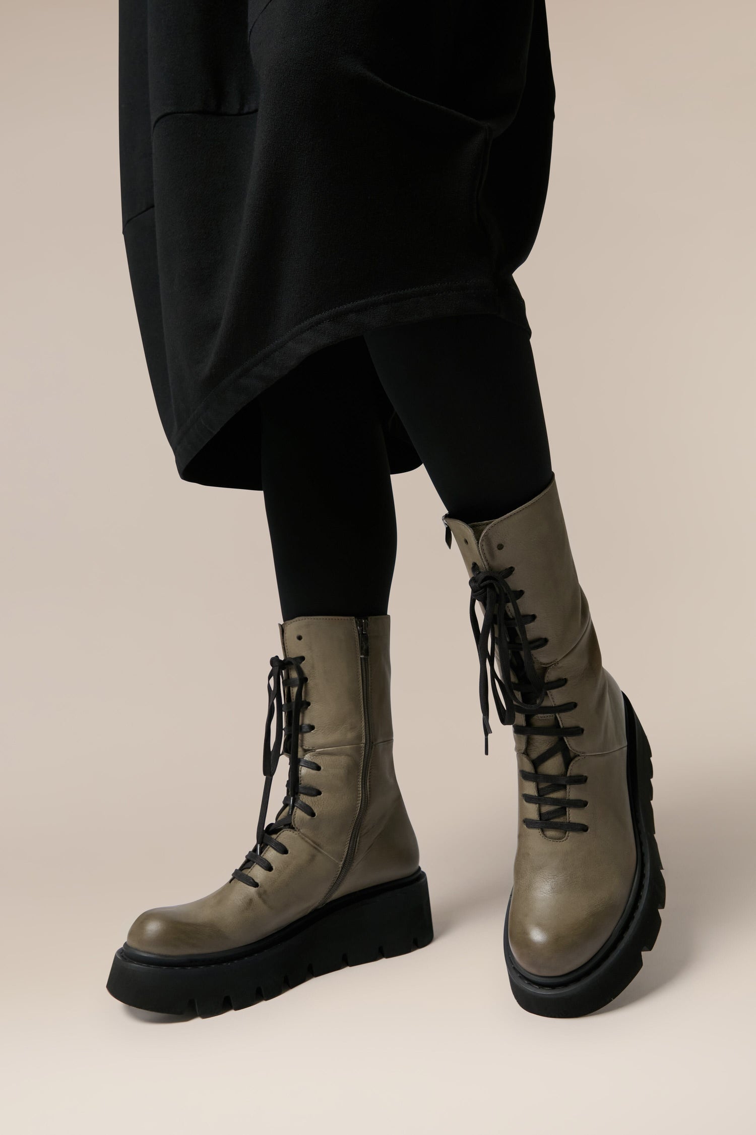 A pair of grey combat boots showcasing Italian craftsmanship – the epitome of Danish design. The Platform Lace Up Leather Boots embody both style and durability, making them a must-have footwear choice for any fashion-forward woman.