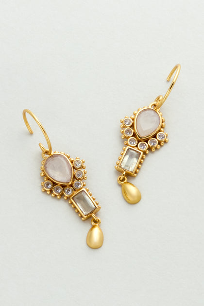 The Gold Plated White Moonstone Ariel Earrings (style MJU11031GB1) feature oval and rectangular gemstones, small round crystals, and teardrop-shaped gold dangles on hook fastenings.