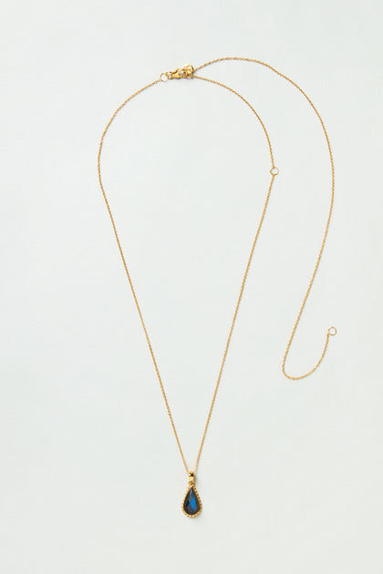 The Gold Plated Labradorite Teardrop Necklace features a teardrop-shaped labradorite pendant on a gold chain, elegantly displayed on a light background.