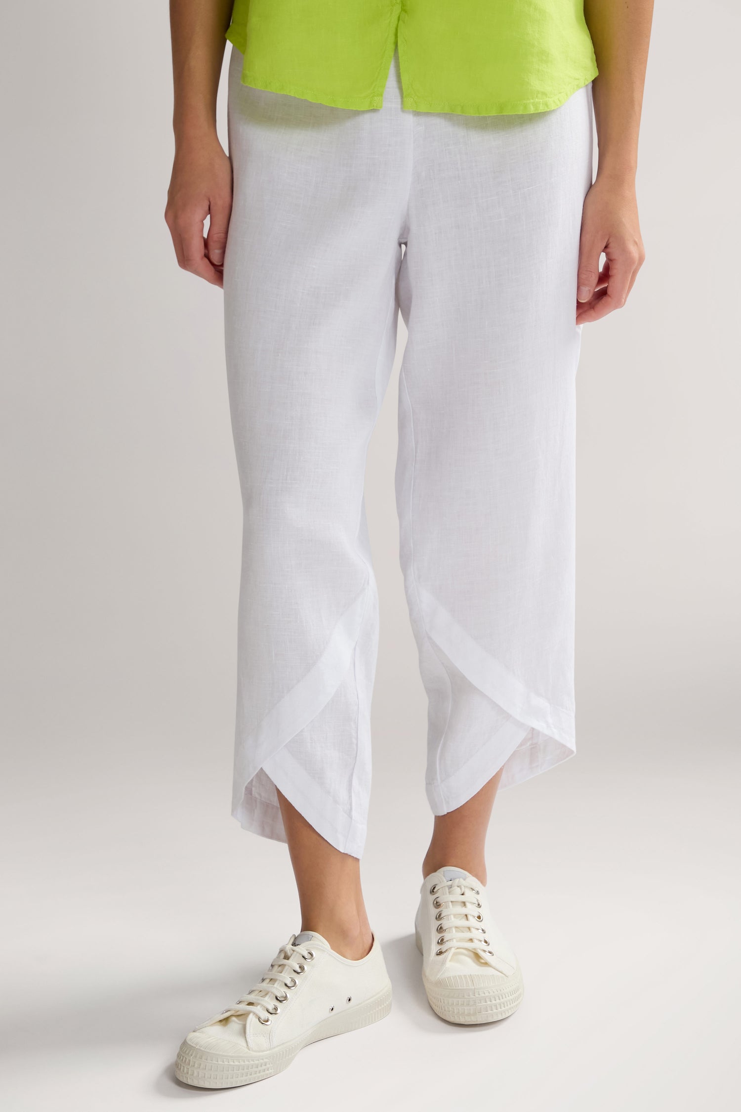 Person wearing white Linen Bubble Trouser, a lime green top, and white sneakers—perfect for a summer staple look with breathable trousers.