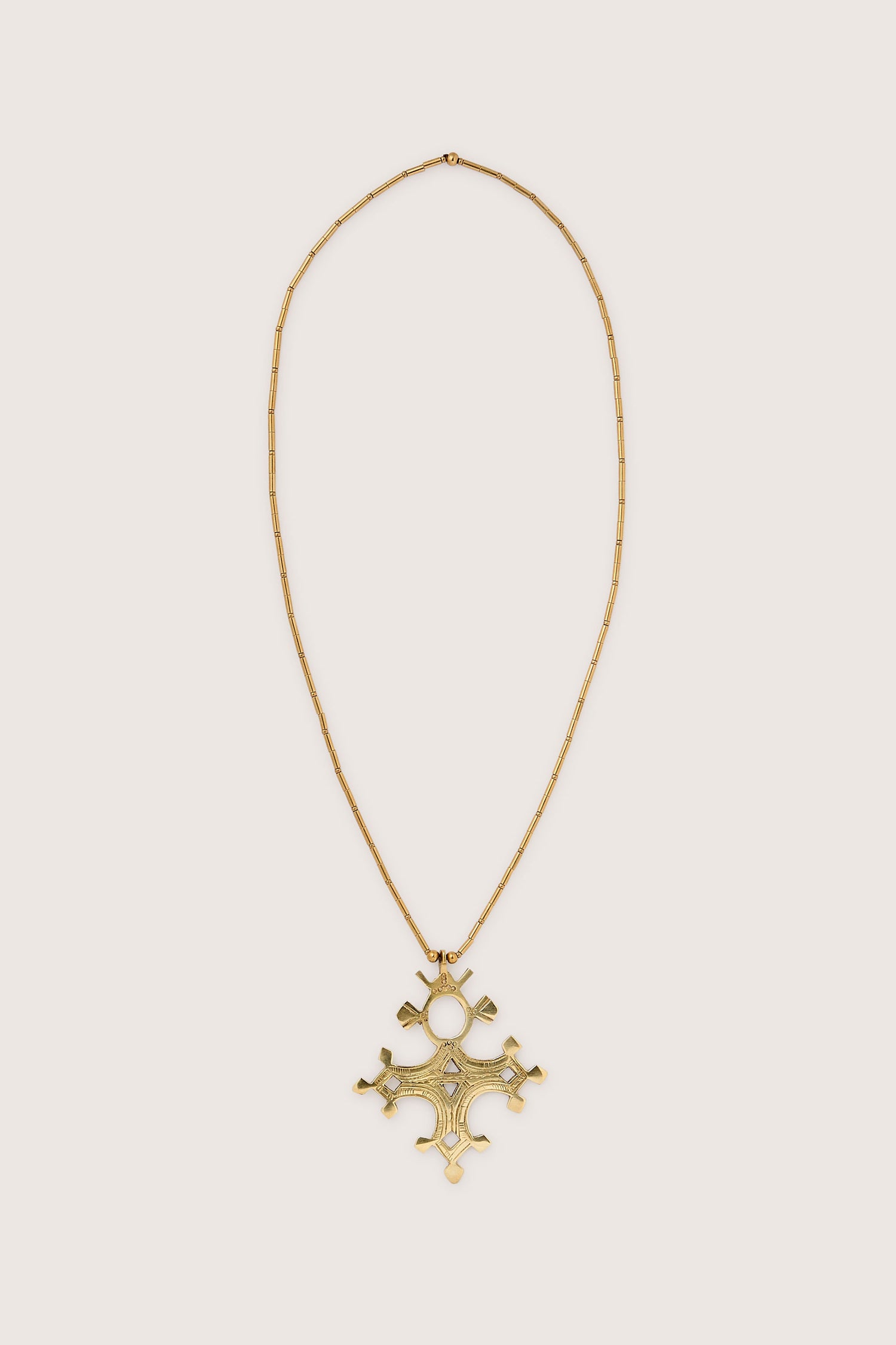 Product Data: Bartchakea Tuareg Pendant Necklace featuring a gold chain, intricate geometric artistry, and a large cross-shaped pendant adorned with gold bugle beads.