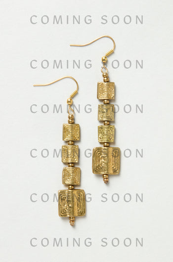 Engraved Squares Earrings (style NCECE175): gold dangle earrings with three stacked, textured square charms each, shown on a light background. "COMING SOON" is repeated over the image.