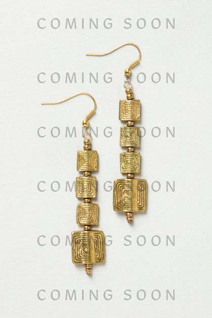 Engraved Squares Earrings (style NCECE175): gold dangle earrings with three stacked, textured square charms each, shown on a light background. "COMING SOON" is repeated over the image.