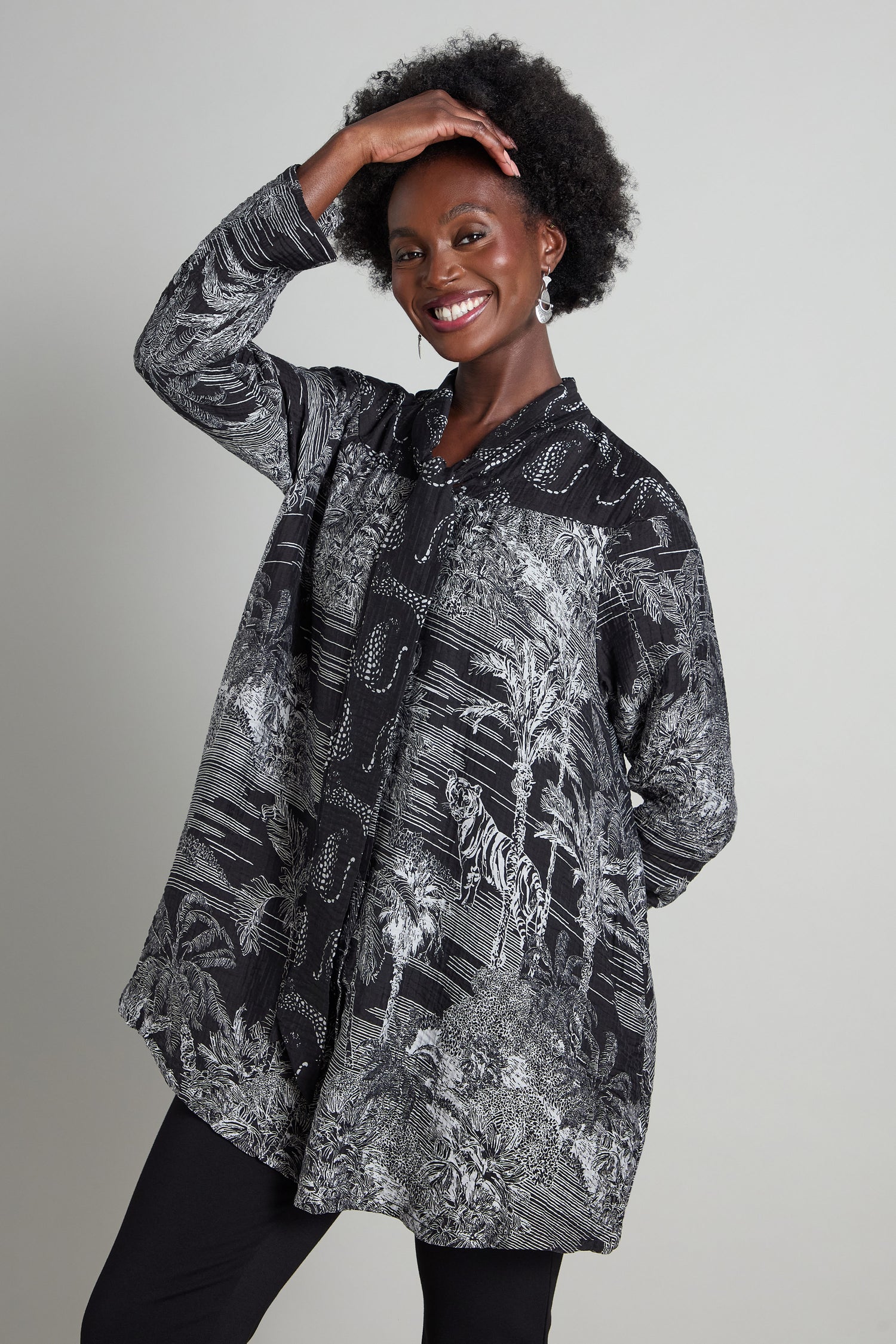 Person smiling while posing in a Tie Neck Viscose Shirt, effortlessly blending style and nature, with one hand on their head against a gray background.