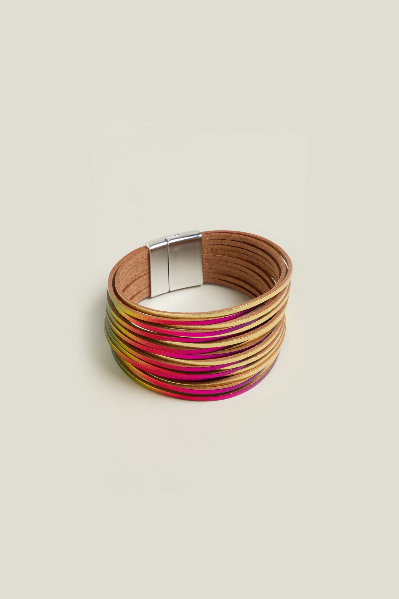 The Woven Metallic Bracelet is a colorful multi-strand twisted leatherette accessory with a magnetic clasp, featuring shades of beige, pink, and yellow against a plain background.