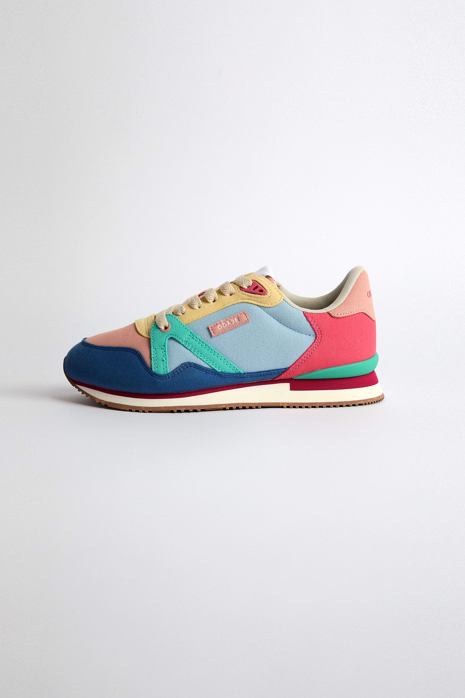 The Andree Trainers feature a playful multicolored design with pink, blue, yellow, and green on a pristine white base. Made from LWG-certified leather, they are both stylish and sustainably crafted.