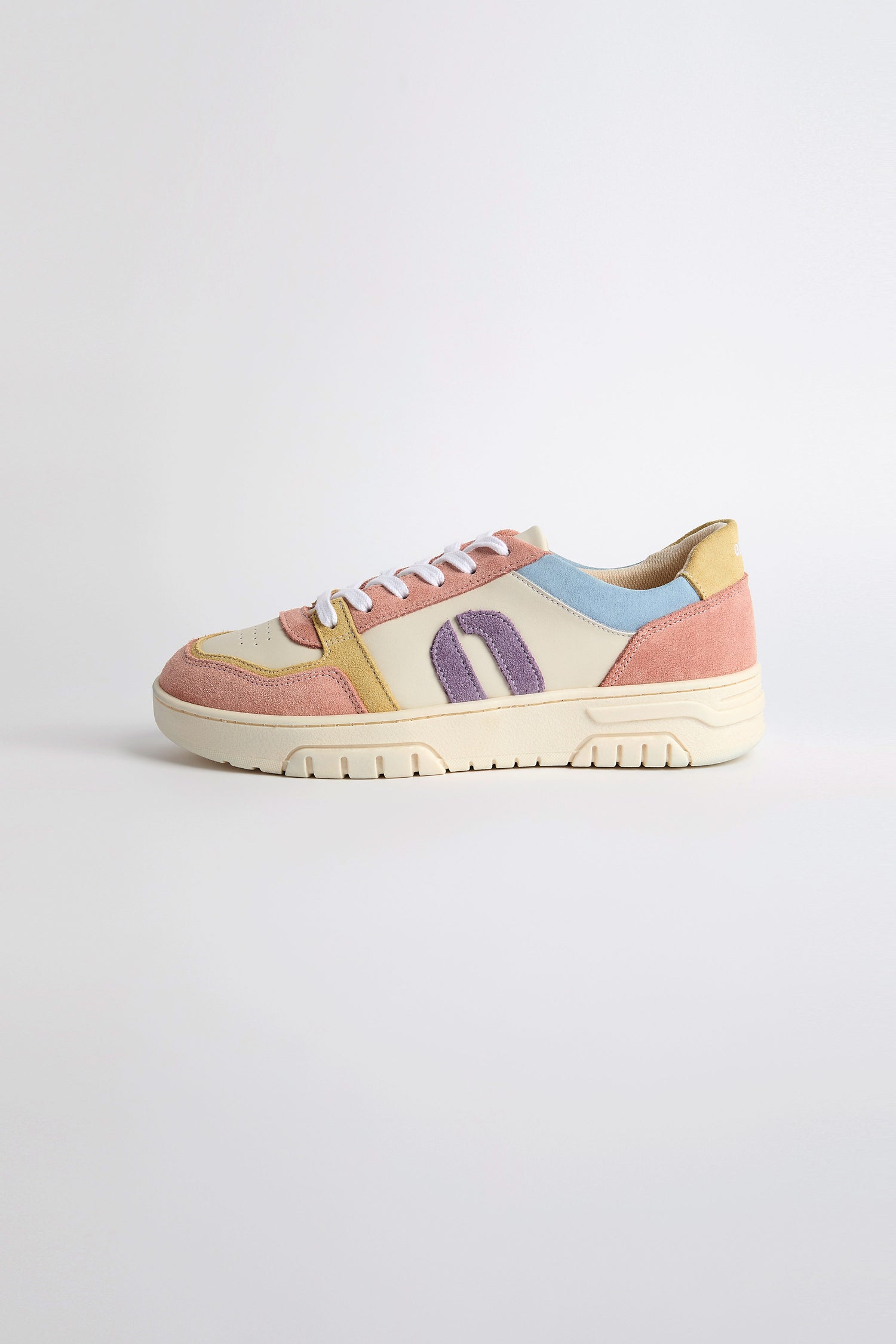 Introducing the sustainable-crafted Nora Trainers, showcasing beige, pink, purple, blue, and yellow panels with white laces on a clean white background.