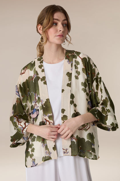 A woman wearing a white top with a luxurious Japanese Acer Kimono.