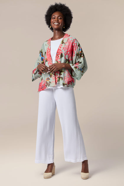 A woman wearing lightweight white wide leg pants and the Chrysanthemum Kimono.