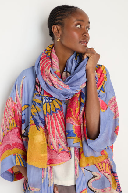 A woman in a Crane Slate Print Kimono with a matching scarf looks to the side against a white background.