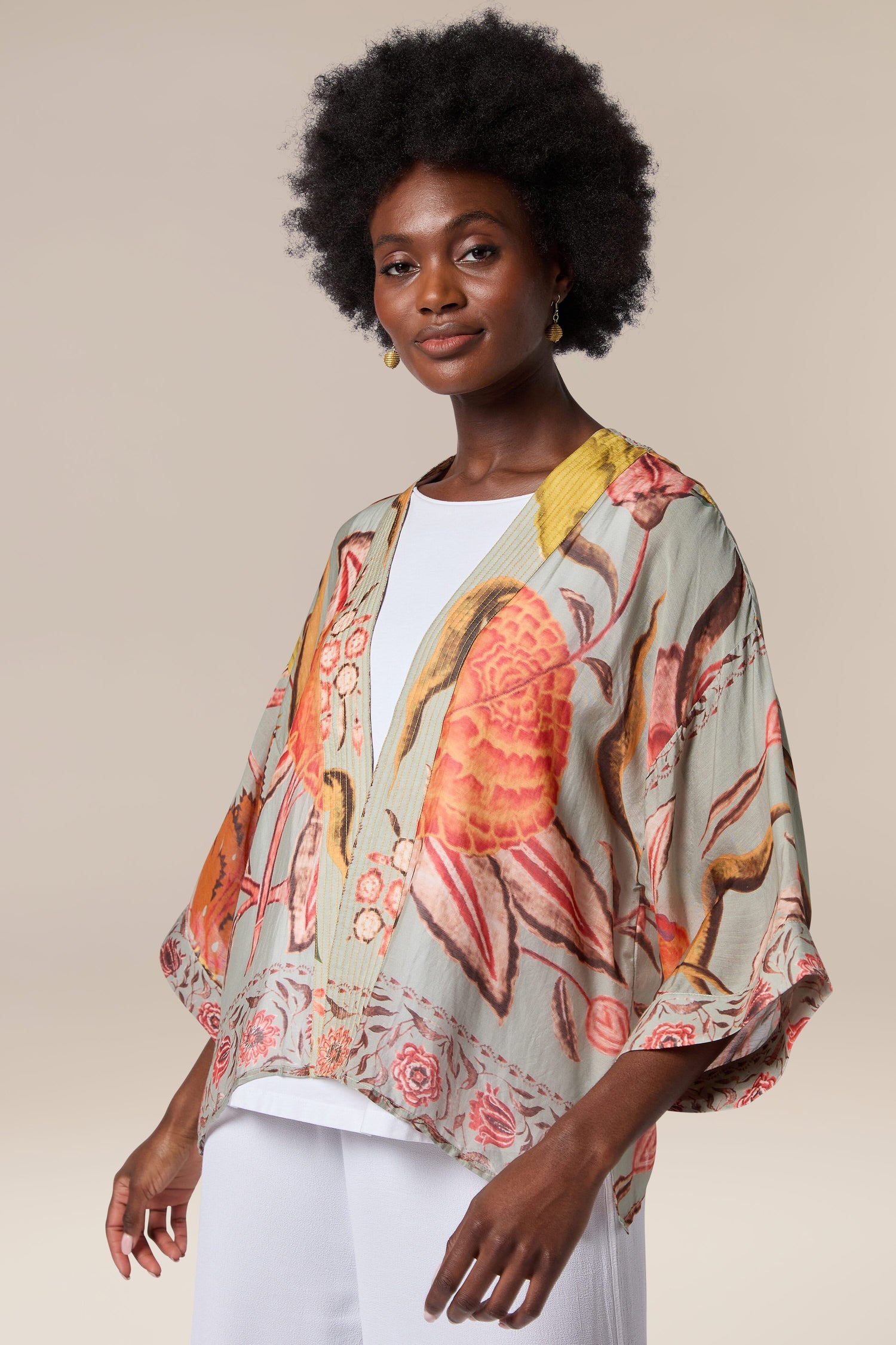 A woman wearing a Joy Kimono with a floral print.