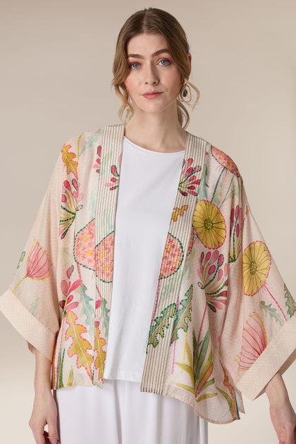 Woman in a white top wearing a Pop Flowers Kimono.