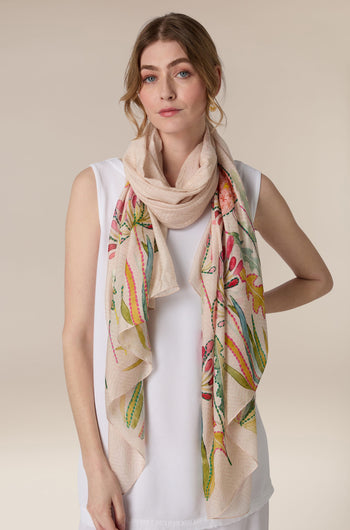 Woman wearing a white top and a Pop Flowers Scarf.