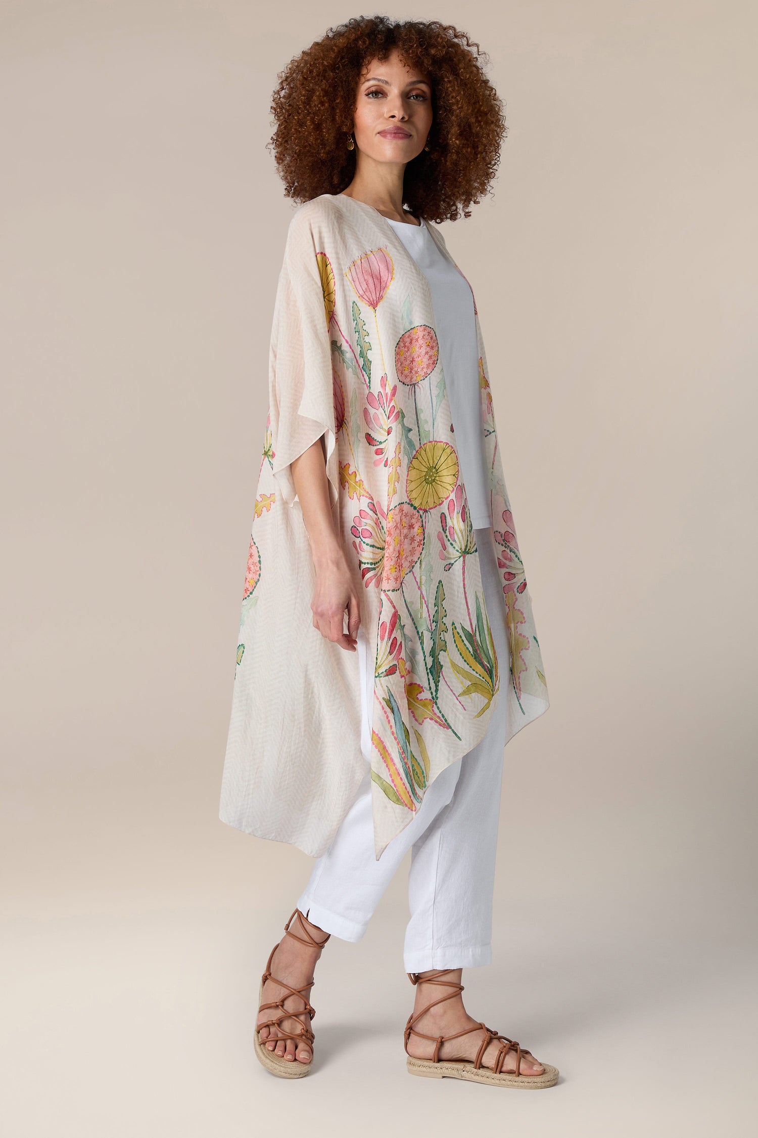 A woman donning a Pop Flowers Throwover for resort wear.