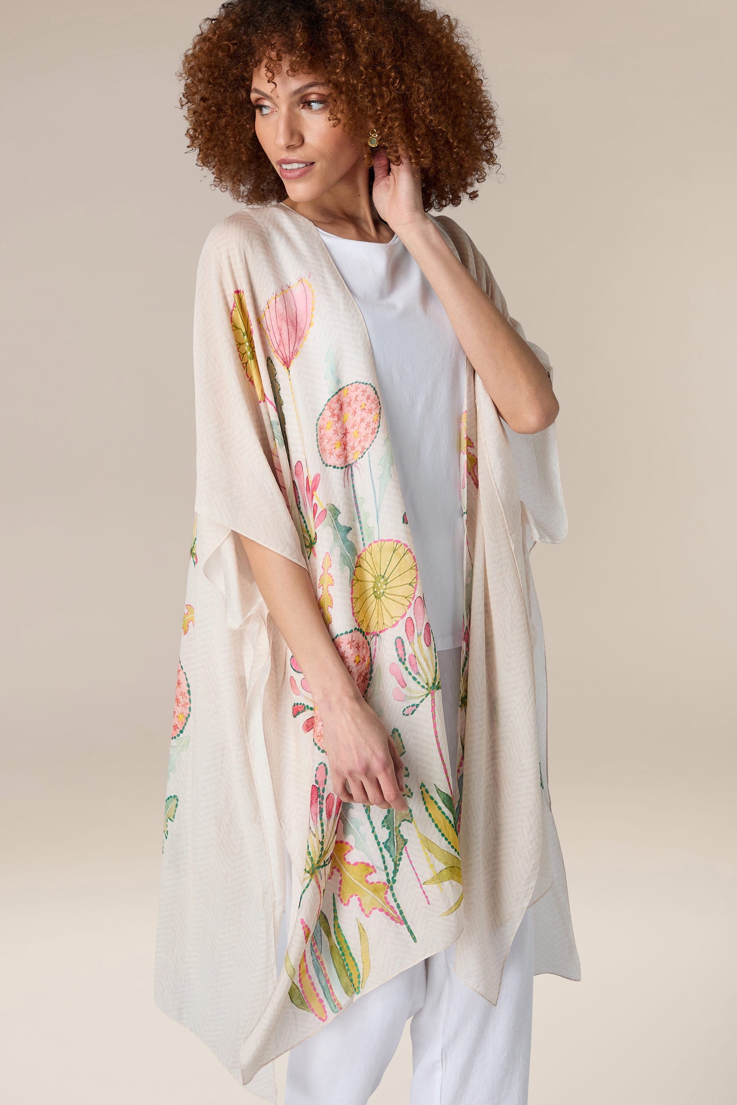 A woman in a Pop Flowers Throwover, perfect for resort wear.