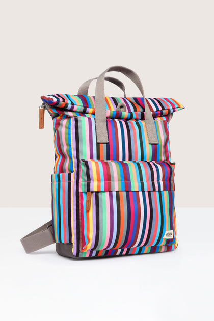 A weather-resistant Recycled Canvas Canfield Bag with a colorful striped design on a white surface.