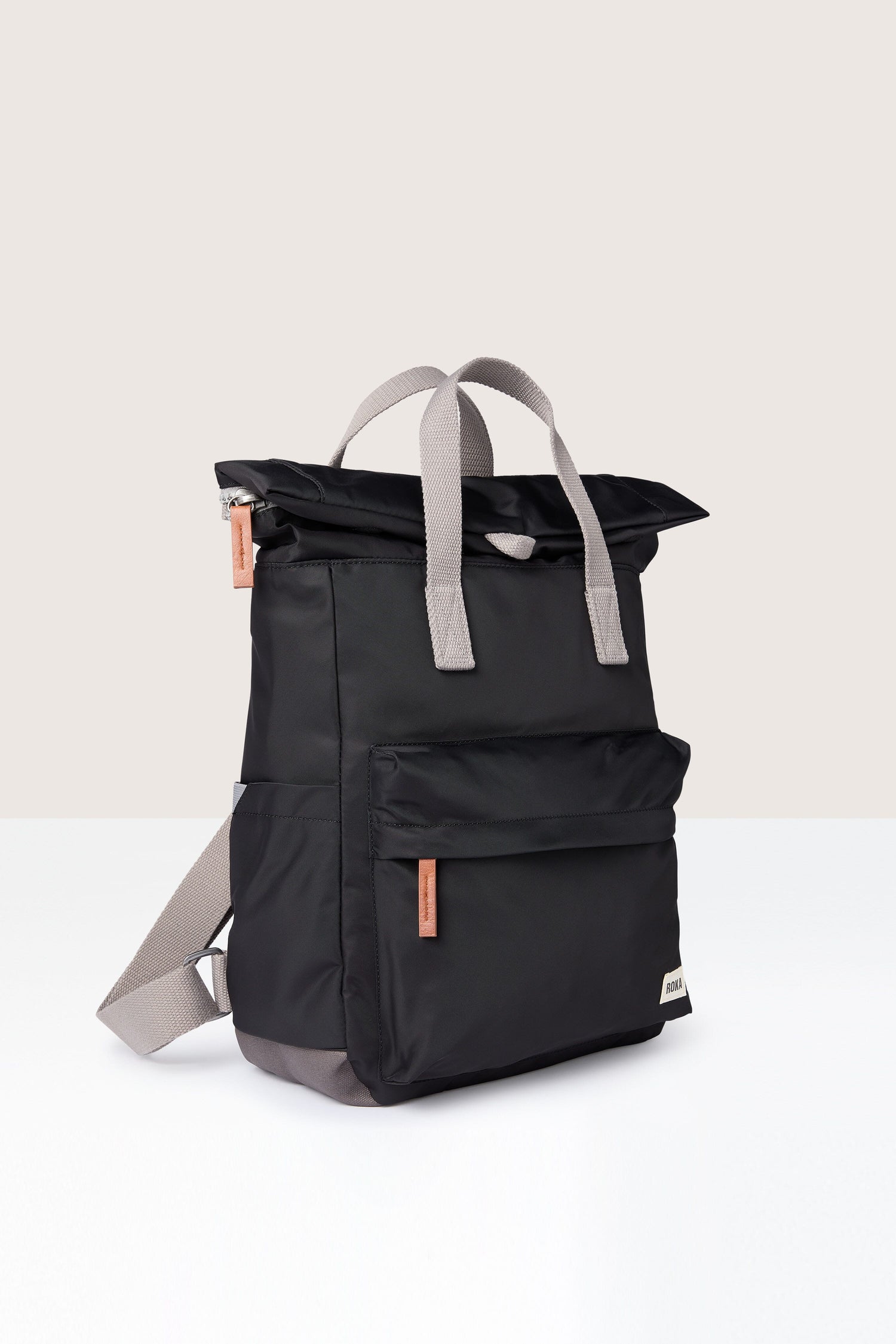 A weather-resistant Recycled Canfield Bag with storage, featuring black color and grey straps against a white background.