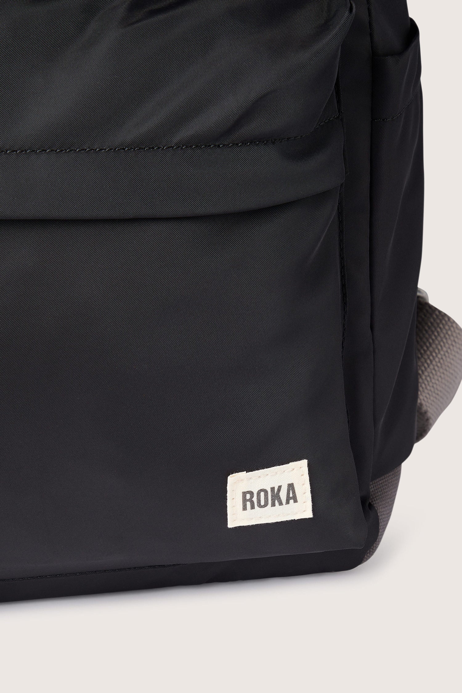 A weather-resistant Recycled Canfield Bag with ample storage and the word roka on it.