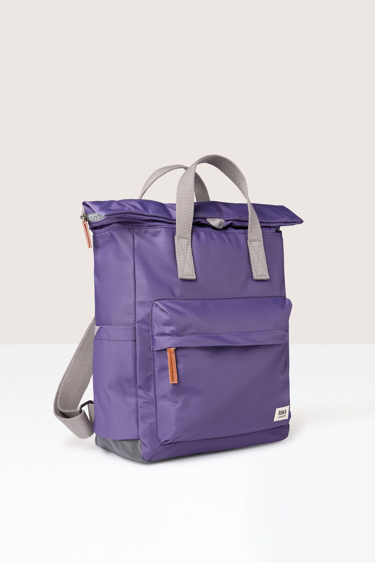 A weather-resistant Recycled Canfield Bag providing ample storage, placed on a pristine white surface.