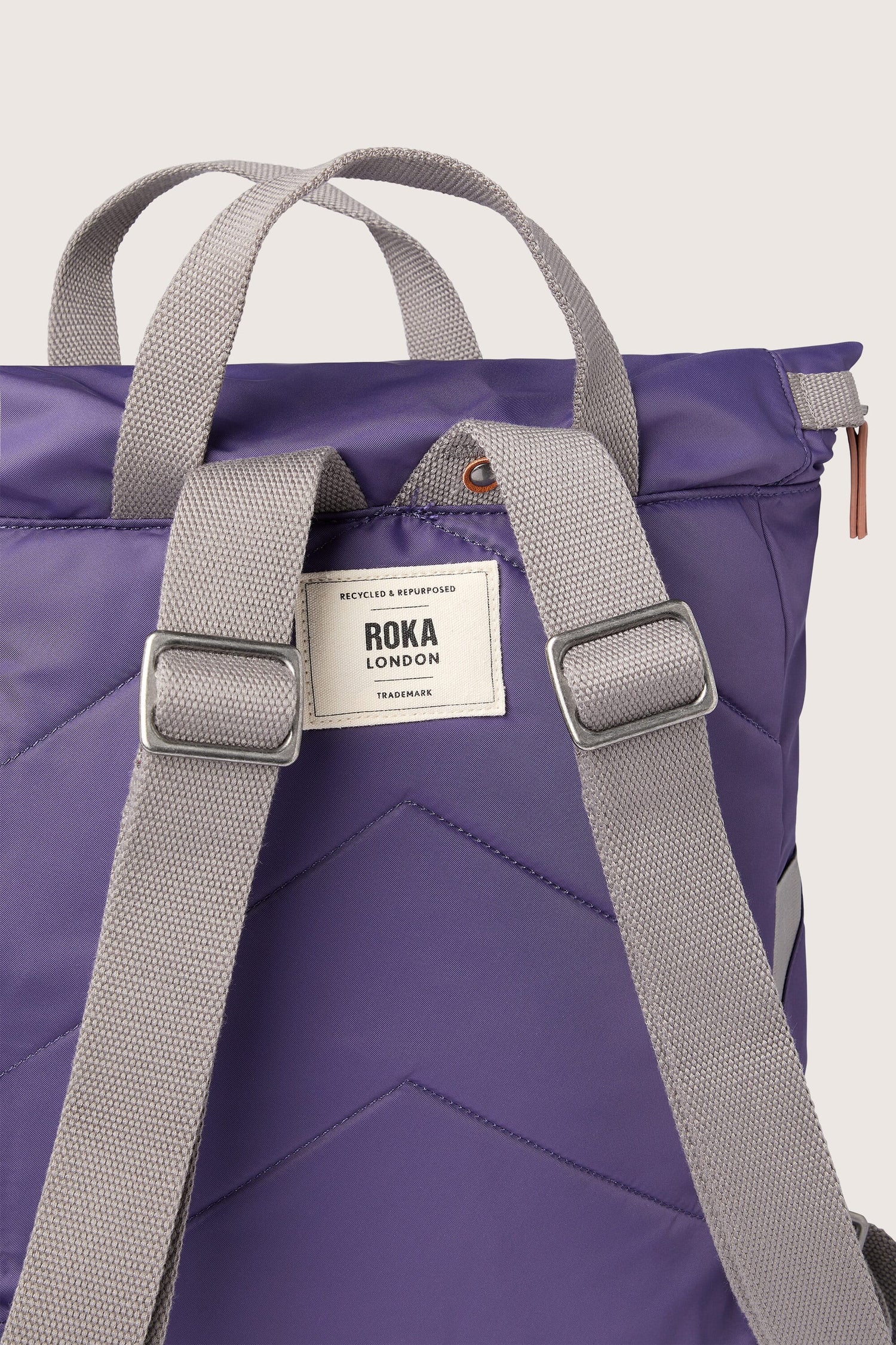 A Recycled Canfield Bag with grey straps.