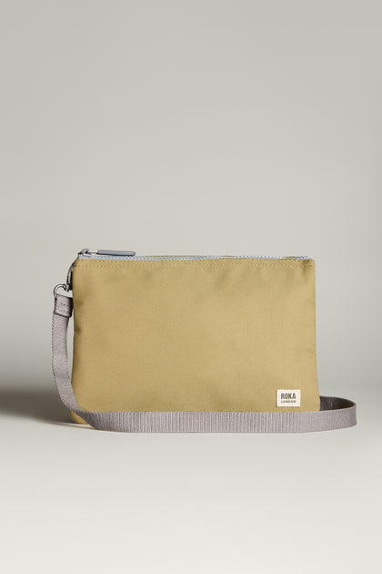 Introducing the Recycled Canvas Carnaby Crossbody Bag, a beige rectangular wristlet made from recycled canvas. It features a gray strap, a small logo label, and is lightweight with weather-resistant properties.