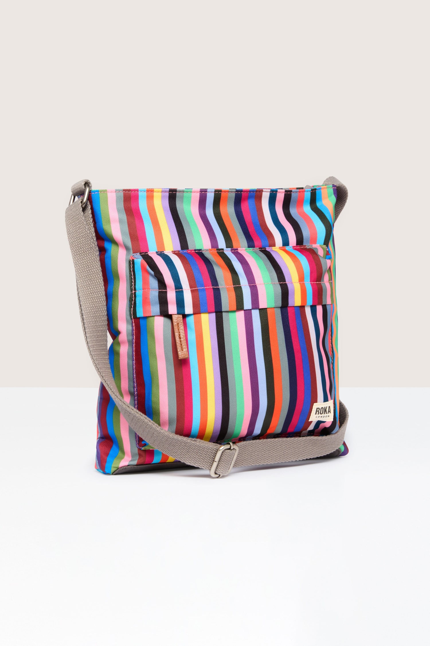 A Recycled Canvas Kennington Bag with a shoulder strap, featuring vibrant stripes.