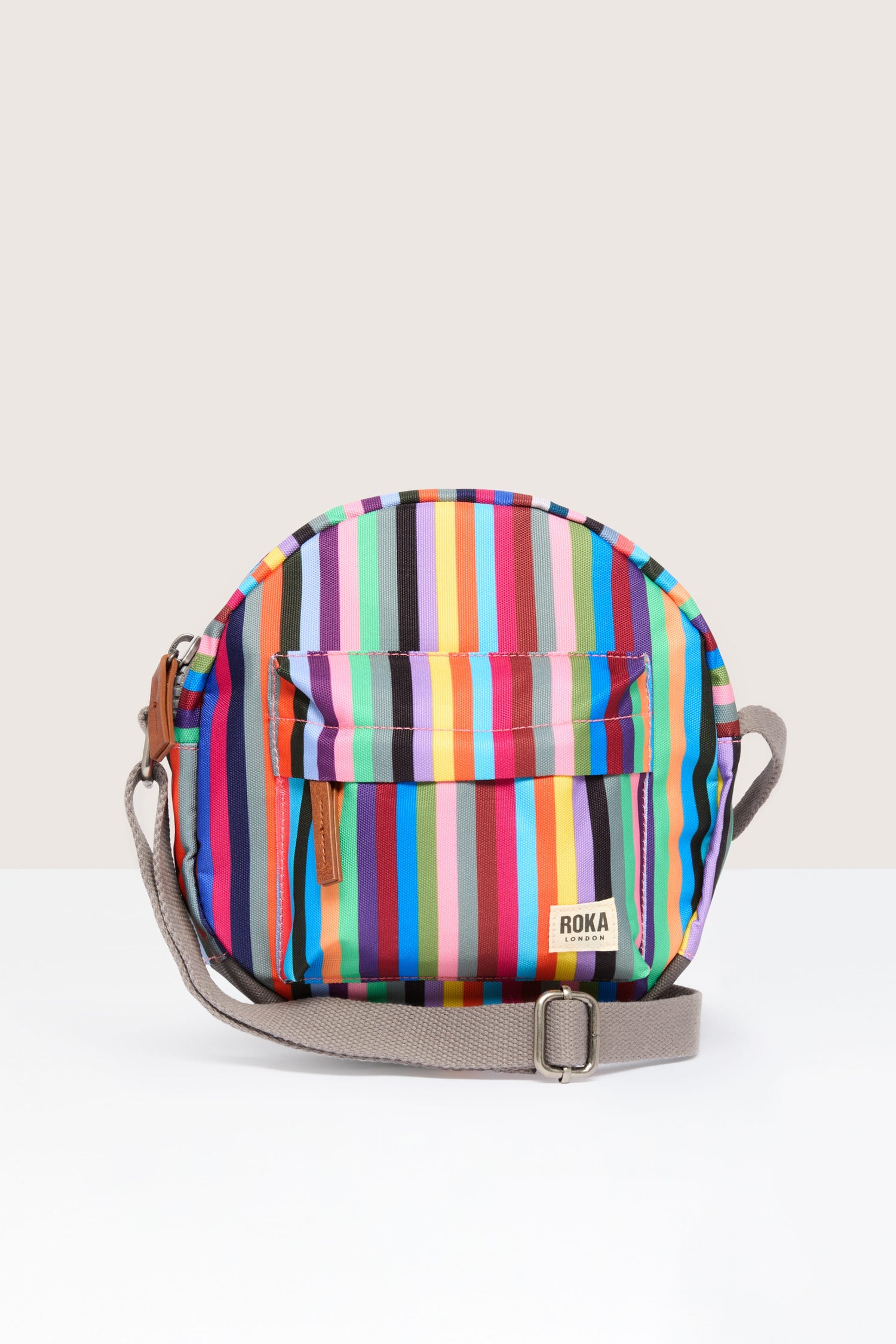 A lightweight and weather-resistant Recycled Canvas Paddington Bag, featuring colorful stripes and a convenient strap for crossbody wear.