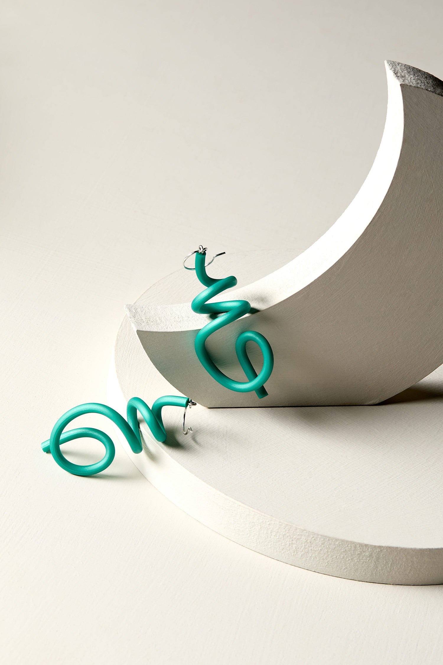 Contemporary jewellery: A pair of Sketch Earrings on a white surface.