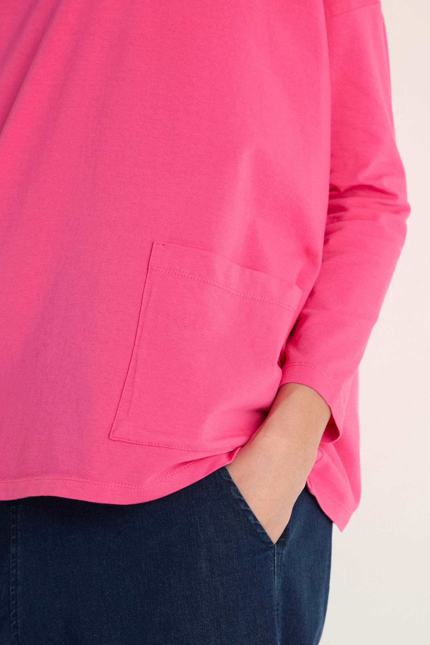 A person wearing a pink Cotton Jersey Boxy Pocket Top with an oversized fit.