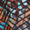 Close-up view of an abstract, stained glass window with colorful geometric patterns in red, blue, orange, and black tones. The intricate design evokes the texture of a Diamond Jacquard Jersey Jacket, blending elegance and artistry in every detail.