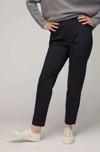 A person models the Ponte Slim Leg Trousers with a grey sweater and white sneakers, standing confidently against a simple backdrop—highlighting this versatile wardrobe staple.