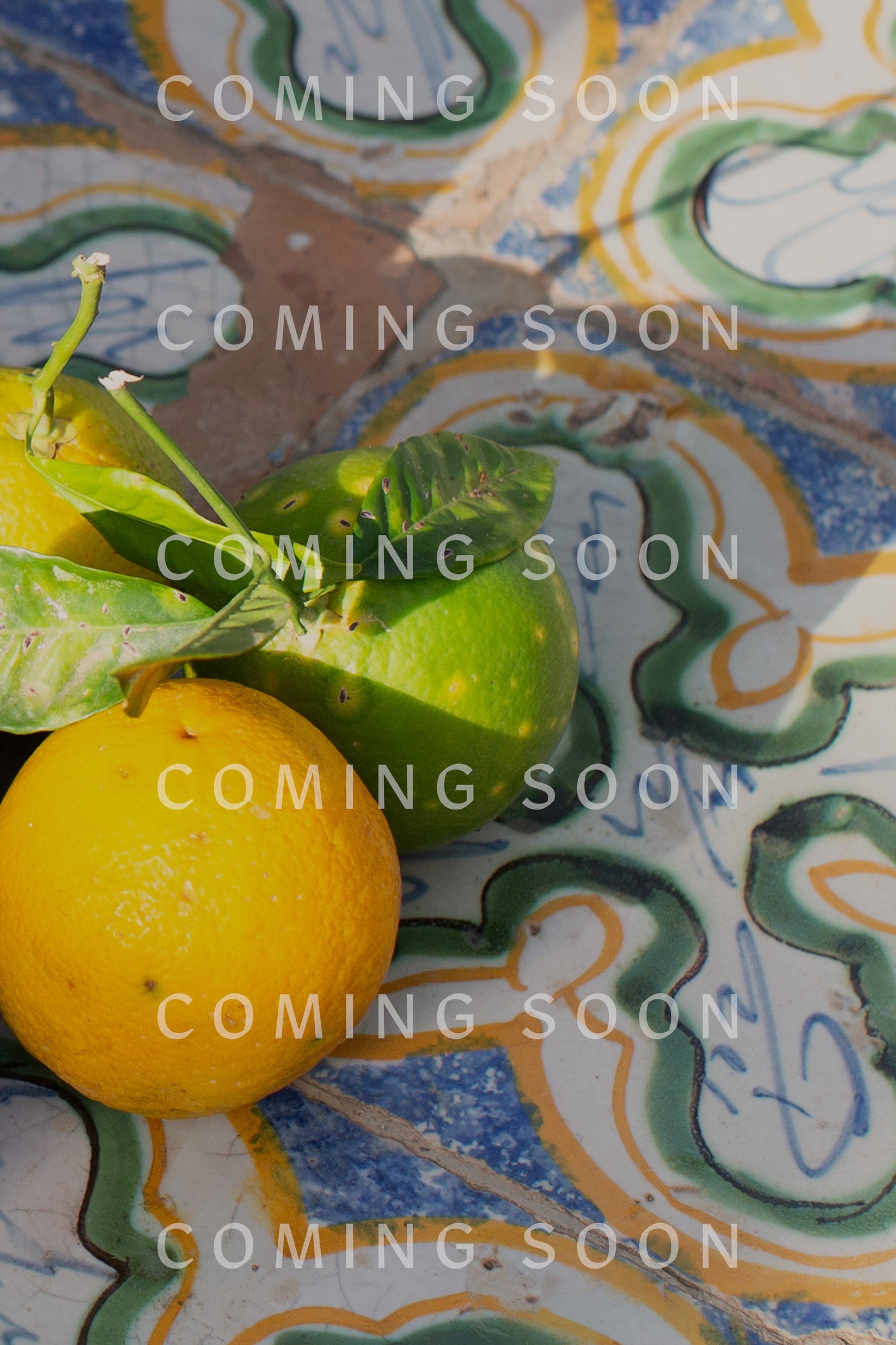 Fresh lemons on decorative tiles with a Cascade Squares Necklace in an "impactful coming soon" overlay text.