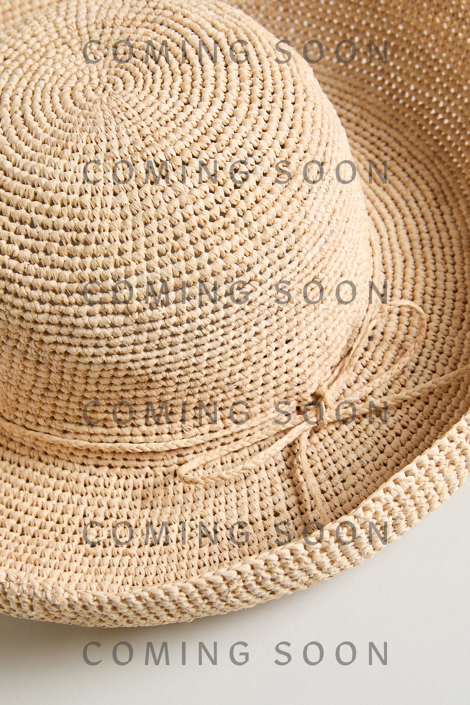 The Handwoven Raffia Tie Hat is displayed against a neutral background with "COMING SOON" and "TON1158" overlaid multiple times on the image.