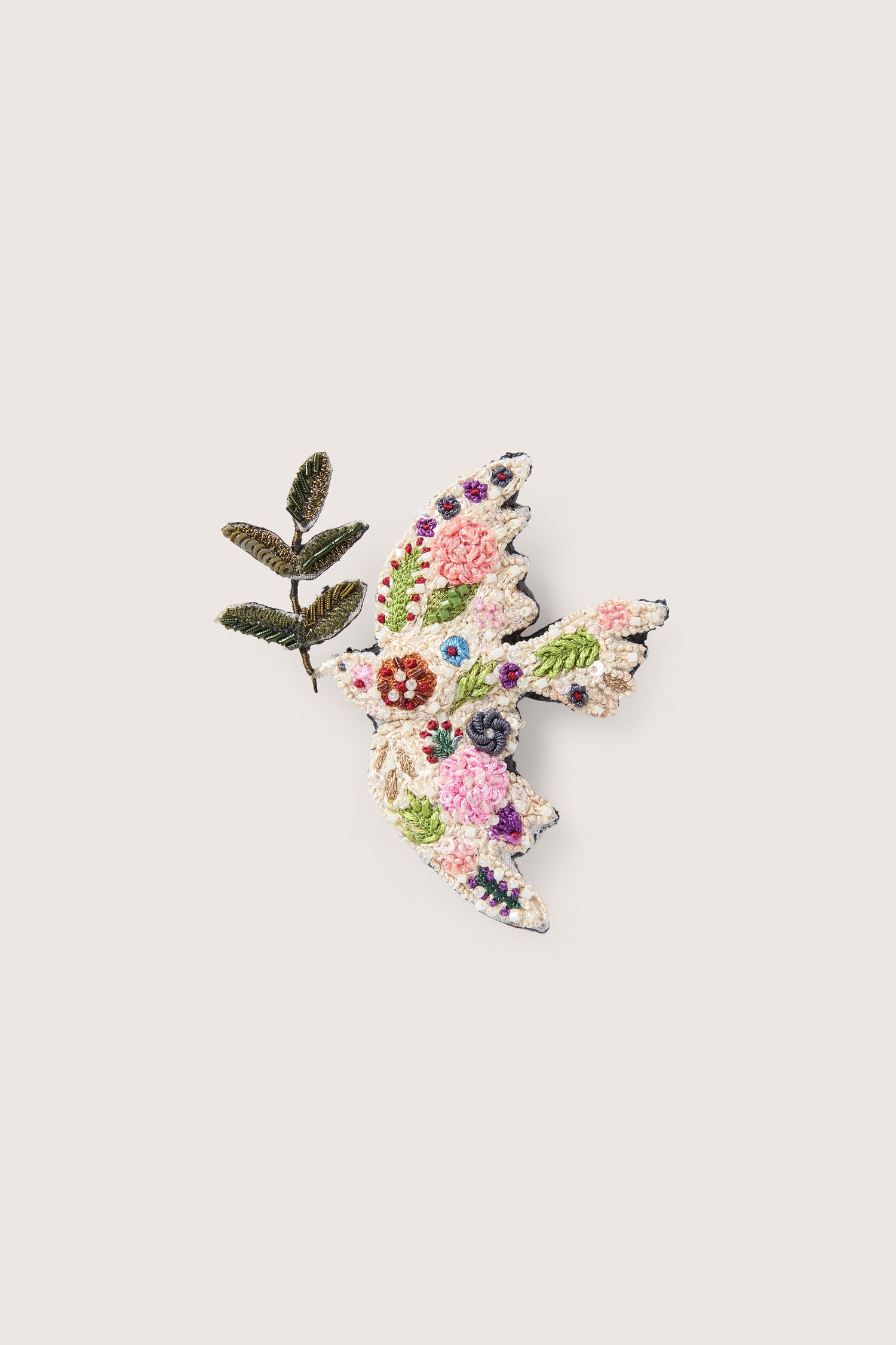 A hand-embroidered peace dove brooch featuring colorful floral patterns and a small branch in its beak against a plain background, showcasing intricate embroidered detailing.