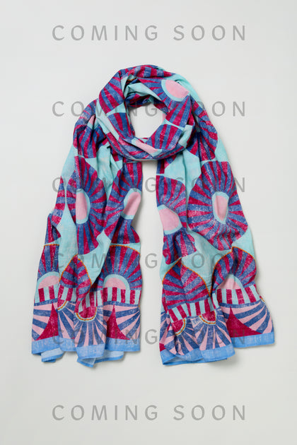 The Embroidered Parasols Cotton Scarf, featuring a blue and pink abstract sunburst pattern, is displayed against a light background with "COMING SOON" overlaid multiple times.