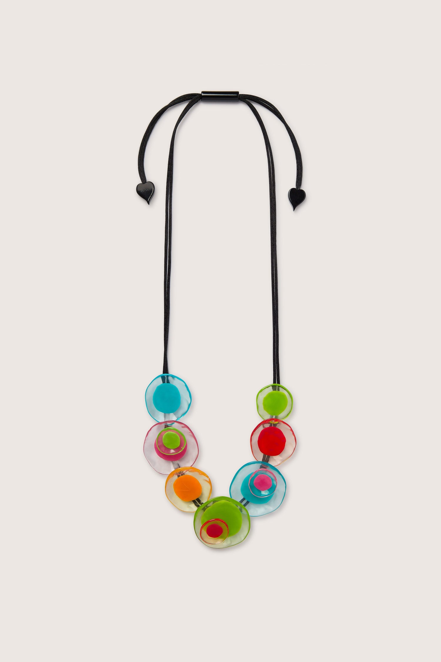 A Resin Flower Necklace with a black cord and colorful disc-shaped beads in blue, pink, green, orange, and red is arranged in a descending cluster. This abstract piece features an adjustable length for perfect fit and style versatility.