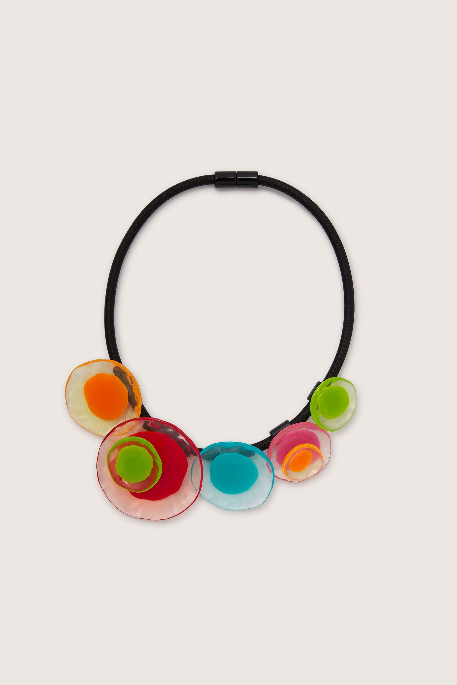 A Short Resin Flower Necklace with colorful, glass-like circular pendants in red, orange, green, blue, and pink features a magnetic closure, offering both convenience and security. This piece embodies artistic expression through its vibrant design.