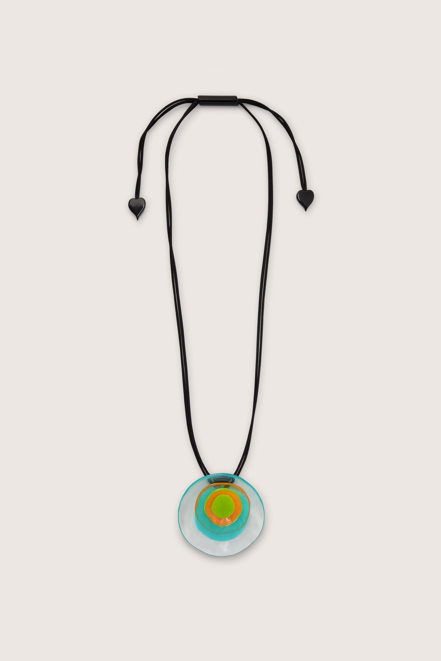 A necklace with an adjustable length black cord and two heart-shaped ends, featuring a circular Resin Flower Pendant with orange, green, and blue layers in an abstract flower design.